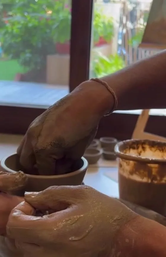 Hands shaping clay during a pottery workshop at Club44